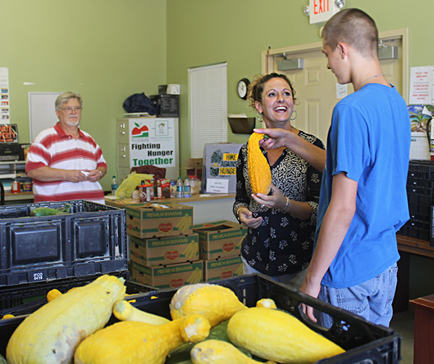 River Cities Harvest director Brittnany Hoback works with a volunteer on a garden delivery for the organization.